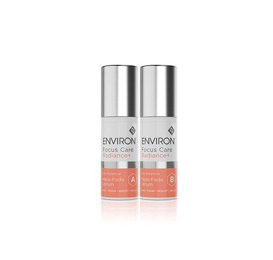 Two bottles of Vita-Botanical Mela-Fade Serum System, with silver caps and coral labels, stand side by side on a white background—an ideal serum duo for targeting discoloration with vitamins and botanical ingredients.