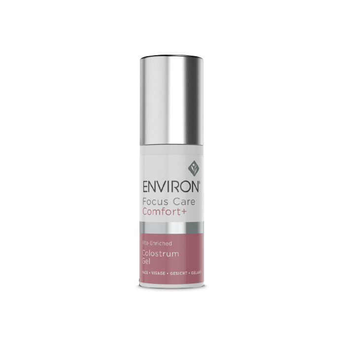 A bottle of Vita-Enriched Colostrum Gel, rich in antioxidants for fine lines, stands upright with a silver cap and a white label accented in pink and grey against a white background.