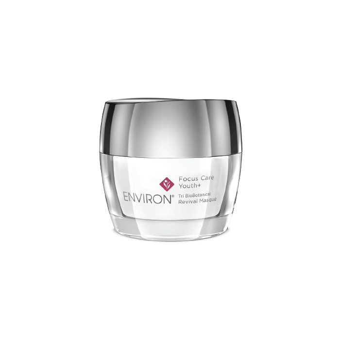 A clear jar with a silver lid labeled Tri BioBotanical Revival Masque, shown on a white background; designed to improve uneven skin texture and photo-damaged skin.