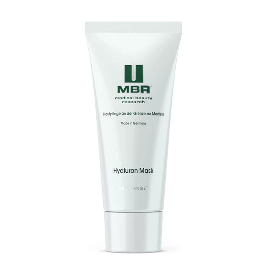 A white tube labeled MBR Hyaluron Mask with green logo and text, containing intensely hydrating hyaluronic acid, stands upright against a white background.