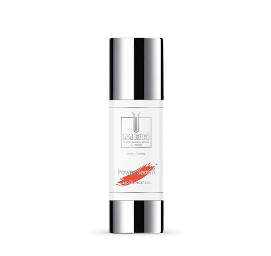 A white bottle of MBR Hautpflege an der Grenze zur Medizin - Power Serum with a silver cap and base, minimalist text, and a red accent on the label, displayed against a plain white background.