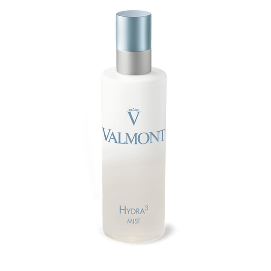 A frosted bottle of Hydra3 Mist with a silver and blue cap, featuring the Valmont logo and product name in light blue text on white—a luxurious hydrating mist for face and body.