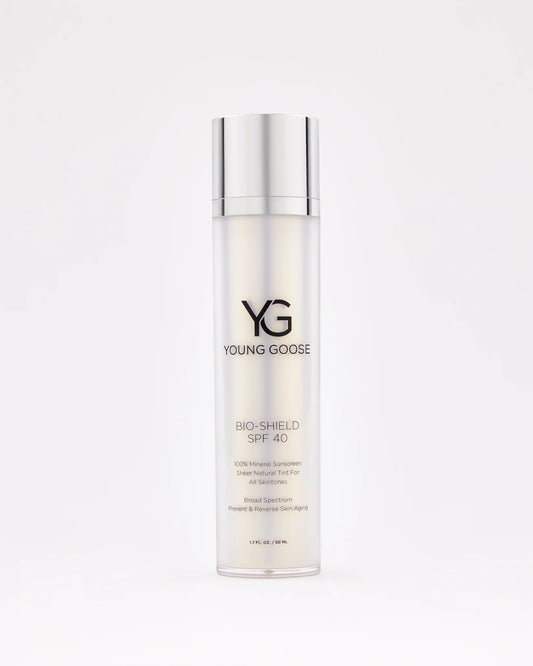 A bottle of Bio-Shield SPF 40 mineral sunscreen, featuring a silver cap and white gradient label with black text, stands upright against a plain white background for superior blue light defense.
