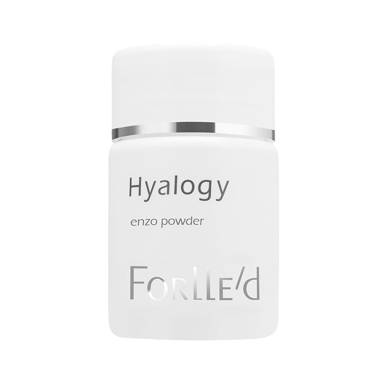 A white container of Hyalogy Enzo Powder with silver accents contains an advanced enzyme facial cleansing powder inspired by Japanese botanicals.