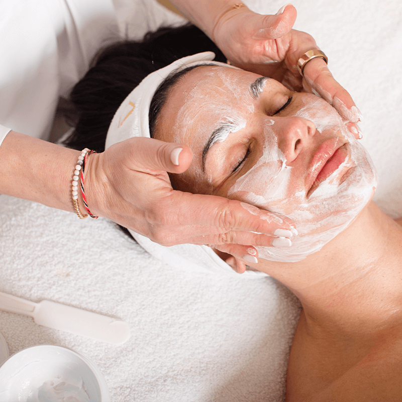 Kataryna's Signature Facial. Image of Kataryna giving facial treatment.