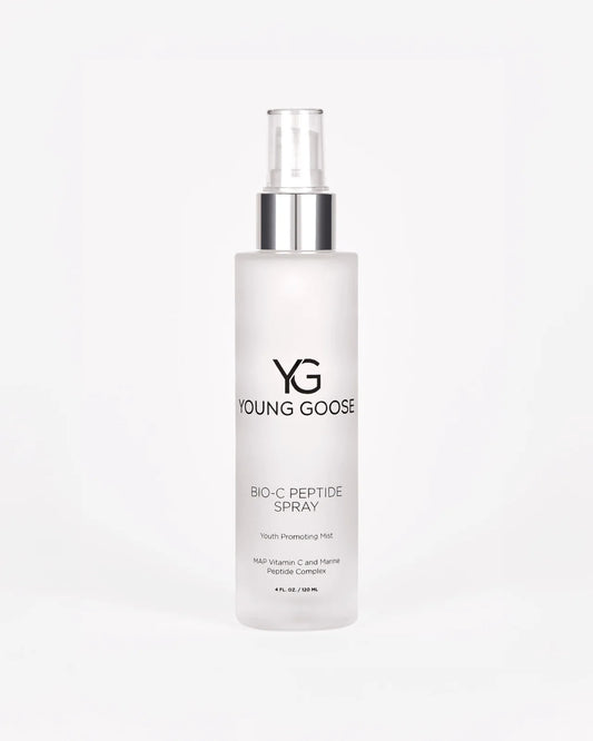 A frosted spray bottle labeled Bio-C Peptide Spray, a youth-promoting mist with blue light protection, featuring MAP Vitamin C and Marine Peptide Complex. Clear cap shown against a white background.