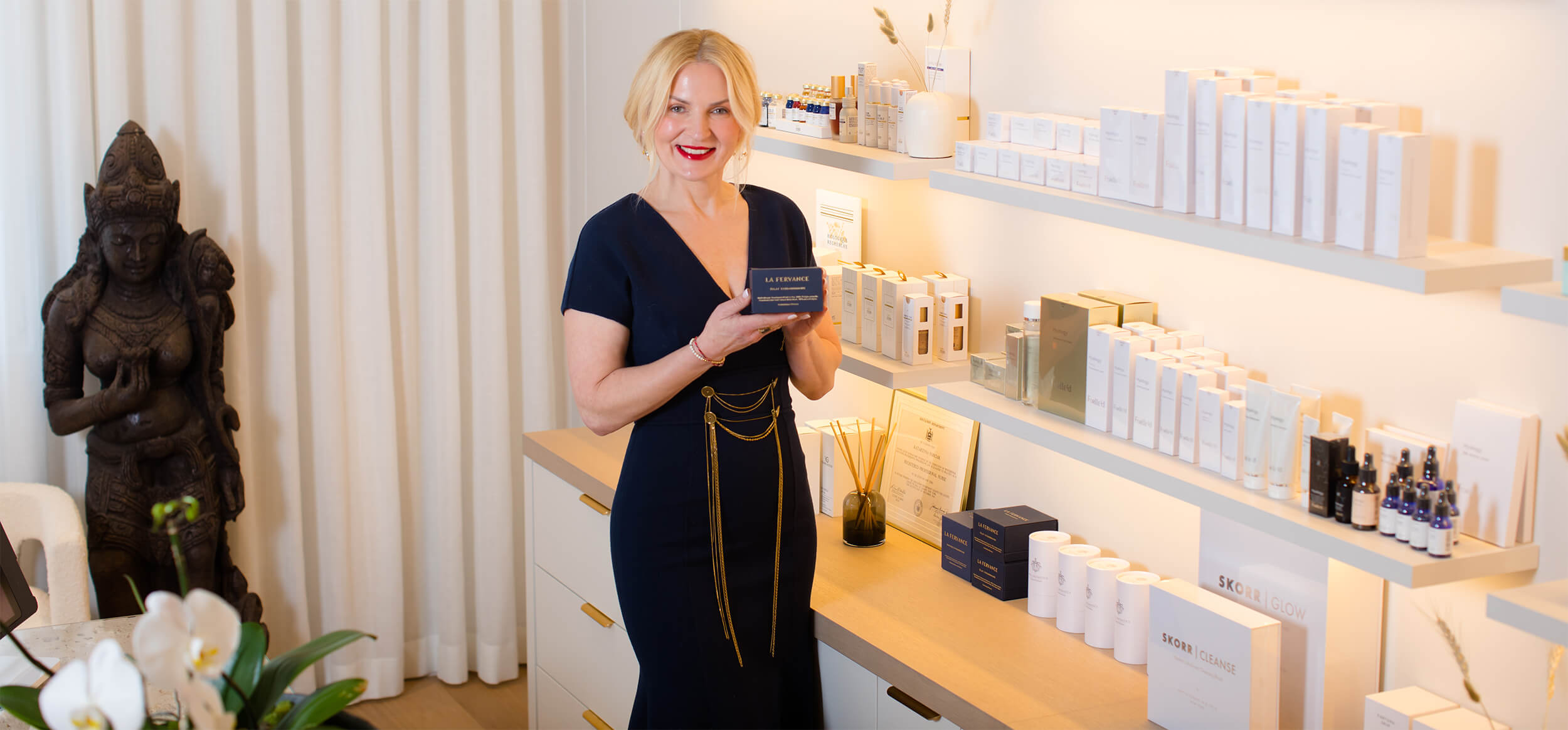Kataryna in store in front of products holding product