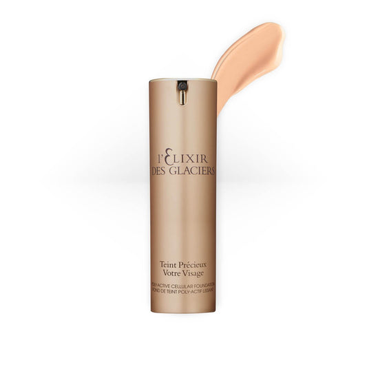 Elixir des Glaciers Teint Précieux in shade Ivory Shanghai, a luxurious foundation in a frosted glass bottle with a gold cap.