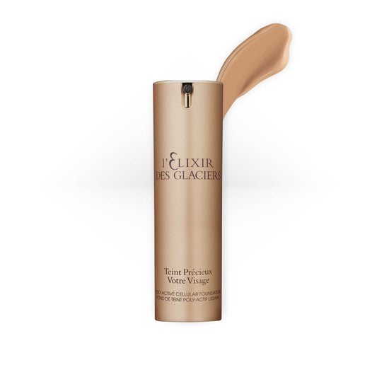 Elixir des Glaciers Teint Précieux in shade Sandy Paris, a luxurious foundation in a frosted glass bottle with a gold cap.