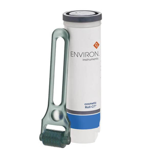 An upright white Environ Cosmetic Roll CIT container with a blue label is shown. In front, there’s a dermaroller featuring micro-needles, designed for skin needling and supporting collagenesis.
