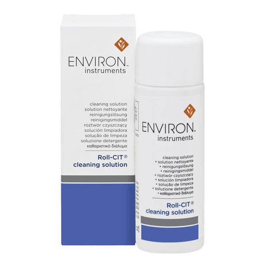 A white bottle and box of Instrument Cleaning Solution for micro-needling devices, with blue and gray text and a logo, are displayed upright against a white background.