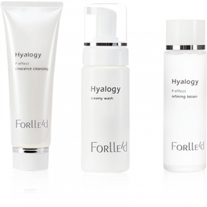 Three white skincare products from Forlled Hyalogy line are displayed: a tube labeled clearance cleansing, a foam pump labeled creamy wash, and a bottle labeled refining lotion.
