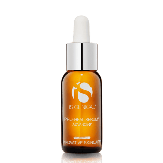 The iS Clinical Pro-Heal Serum Advance 15ml comes in an amber glass dropper bottle with a white cap and label, offering a potent vitamin C formula for anti-aging and antioxidant protection, displayed upright against a white background.